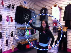 Owner Linda Costoff shows one of the Hula Hoops at Intrigue Fitness